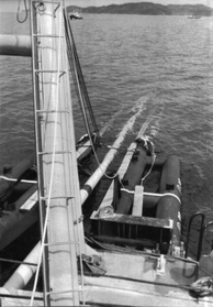 敷設船上で溶接され、船尾から次々と海底に沈められるパイプ＝１９８３（昭和５８）年４月８日、飾磨郡（姫路市）家島沖、油島丸船上