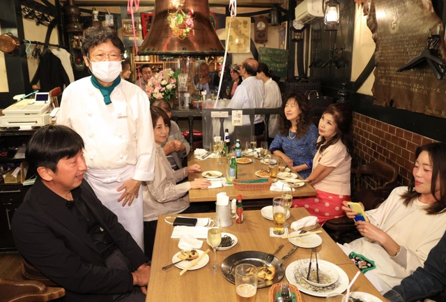 村上春樹さんがノーベル文学賞に選ばれず、落胆するファンの「ハルキスト」と、オーナーシェフの山中崇裕さん（左から２人目）＝６日夜、神戸市中央区中山手通２、ピノッキオ（撮影・吉田敦史）