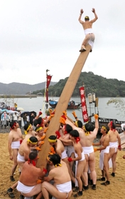 神輿を船に乗せるためのバタ板の上に乗り、３年ぶりの盛り上がりを喜び合う男衆＝９日午後、赤穂市坂越
