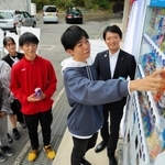 兵庫高校に設置された「おしゃべり自販機」で飲み物を買う生徒ら。斎藤知事の声でメッセージが流れる＝神戸市長田区寺池町１