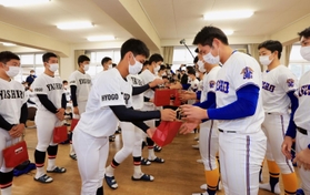 県岐阜商の選手たちにプレゼントを手渡す社の選手たち＝２３日午前、加東市木梨、社高校（撮影・鈴木雅之）