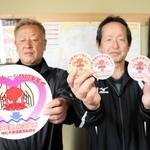 タコマイレージ制度で、マダコの提供者に配ったステッカーを持つ明石市漁業協同組合連合会遊漁船部会の松本正勝会長（右）ら＝明石市二見町東二見