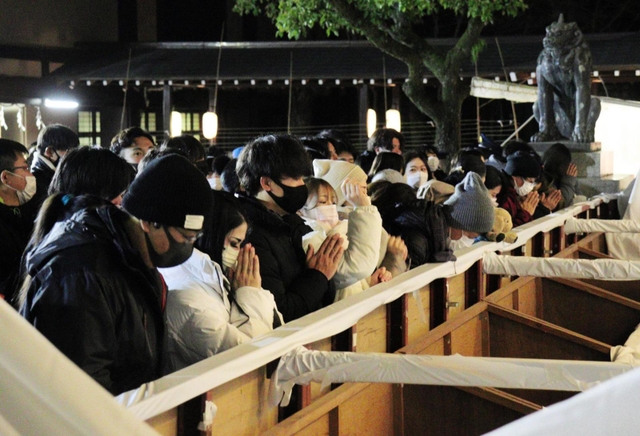飛躍の１年になりますように－。真剣な表情で手を合わせる参拝者＝１日午前、湊川神社