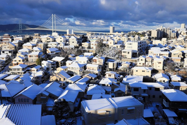 明石海峡大橋を望む住宅街。昨夜からの降雪で屋根が白く染まった＝２５日午前７時５８分、神戸市垂水区高丸５から