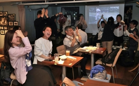 ３回表、侍ジャパンの岡本が３ランを放ち、一挙に４-０と点差を広げて歓喜する野球ファンら＝１６日夜、神戸市中央区、スポーツカフェバー「スポルテリア」
