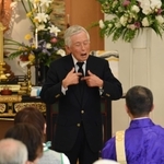 手話と身ぶりで神戸空襲の悲惨さを伝える山村賢二さん＝２０１８年３月１７日、神戸市兵庫区今出在家町４、薬仙寺