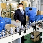昨春に続き、４月の賃上げを決めた神戸合成。本社工場で働く従業員をねぎらう宮岡督修社長（左から２人目）＝小野市匠台