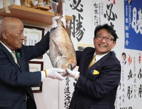 支援者から贈られたタイを手に当選を喜ぶ清元秀泰氏（右）＝姫路市安田２（撮影・辰巳直之）
