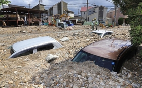 天神川の堤防が決壊し、土砂に埋もれた車＝８日午前、伊丹市荒牧６（撮影・吉田敦史）