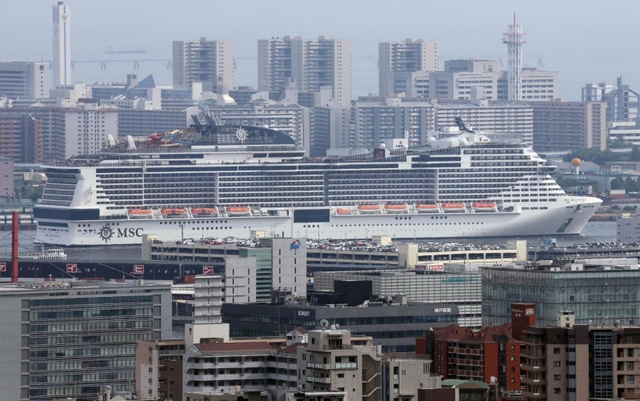 神戸のビル群に溶け込む「ＭＳＣベリッシマ」＝１３日、神戸市灘区の灘丸山公園から