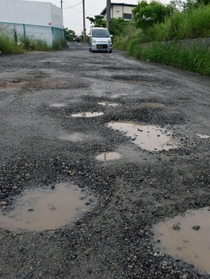 穴だらけの県道長坂垂水線＝神戸市垂水区多聞町と同市西区伊川谷町長坂の境界付近（撮影・中西幸大）