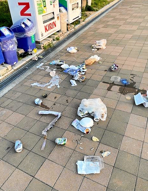 自動販売機前の通路上に散乱した食品容器や酒の空き缶（難波久芳さん提供）＝神戸市中央区波止場町