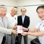 県高野連の笠間龍夫事務局長（右）に寄付金を手渡す兵庫グランドＯＢ親睦会の（左から）武蔵健児さん、桑原一之さん、永田剛司さん＝神戸市中央区、県高野連