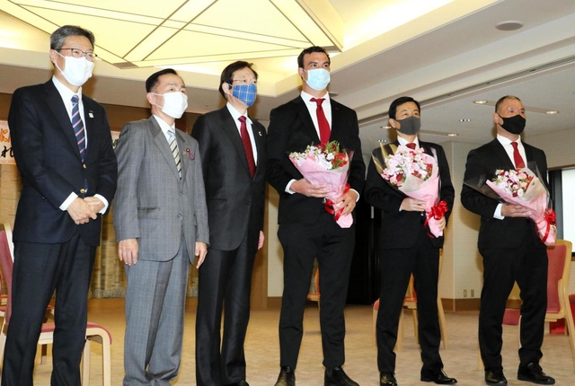 神戸市の久元喜造市長（左から３人目）らと記念撮影に臨む神戸製鋼のトム・フランクリン共同主将（同４人目）＝神戸市役所