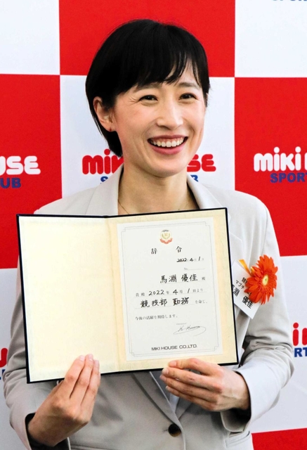 ミキハウスの入社式で辞令を手に笑顔を見せる馬淵優佳＝１日、大阪府八尾市の同社本社