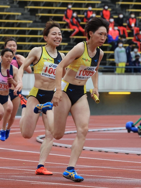 一般女子４００メートルリレー決勝　ＫＡＧＯＴＡＮＩのアンカー安田明日翔（右）にバトンを渡す３走横田華恋＝ユニバー記念競技場（撮影・吉田敦史）
