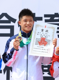 男子高飛び込みで優勝し、メダルと賞状を手に笑顔の須磨学園・玉井陸斗