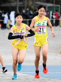 女子・稲美　１区吉川菜緒（右）からたすきを受け走り出す２区湊友希