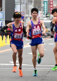 区間賞を獲得した兵庫の２区新妻遼己（右）から３区の目片将大にたすきリレー＝広島市内