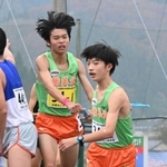 男子・稲美北の１区中川悠聖（左）からたすきを受け、走り出す２区山田遼翔（撮影・大田将之）