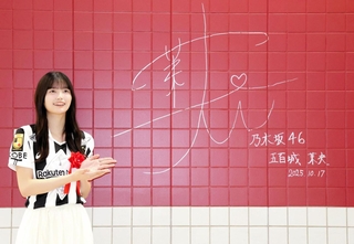 御崎公園駅でＪ１神戸カラーの深紅の壁にサインした乃木坂４６の五百城茉央さん＝神戸市兵庫区、同駅