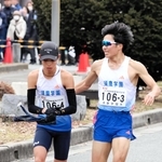 男子の須磨学園Ａ３区梅田大陸（右）がトップを奪い、４区上山宙大へリレー＝西脇市