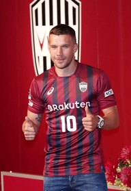 Ｊ１神戸への入団会見でユニホーム姿を披露したＦＷポドルスキ。得点力に期待が集まる＝６日午後、神戸市中央区、神戸ポートピアホテル（撮影・小林良多）