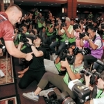 入団会見でカメラマンにケーキを振舞うルーカス・ポドルスキ選手＝神戸市中央区、神戸ポートピアホテル