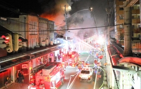 消防車両などが駆け付け、通行止めになった大開通＝１３日午後６時３７分、豊岡市中央町