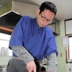 香住ガニを包丁でさばく石田裕二さん＝香美町香住区香住