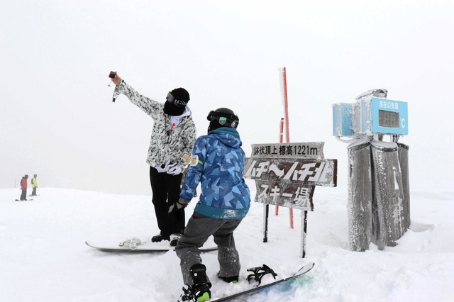 鉢伏山の頂上付近で記念撮影するスノーボーダーたち＝１月