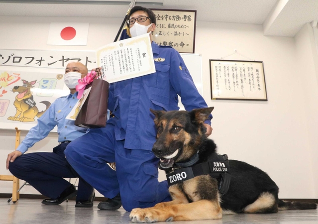 行方不明者を発見して表彰されたゾロ号と県警鑑識課の田中晶博巡査長（右）＝南但馬署