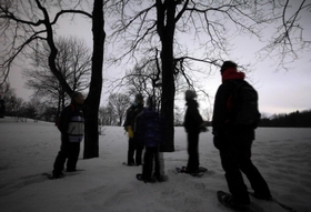 雪の積もる夜の森を散策する参加者ら＝兎和野高原（３１秒露光）