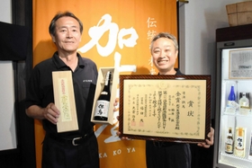 全国新酒鑑評会の金賞受賞酒と、木村祥三社長（左）、勝原誠杜氏＝此の友酒造