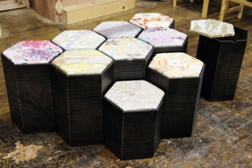 高さが異なる六角形の椅子で、座面には絹織物の帯地を再利用した。椅子の中は収納が可能＝豊岡市小島