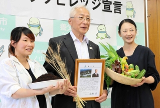 オーガニックビレッジを宣言した広瀬栄養父市長（中央）と、田村麻里奈さん（左端）、青木幸さん＝養父市役所