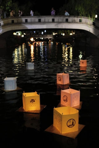 夜の川面に幻想的に浮かぶ灯籠＝豊岡市城崎町湯島