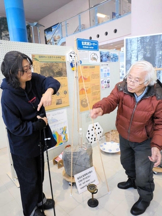展示物を説明する山陰海岸ジオパーク館の谷本勇館長（河合美智子さん提供）