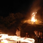 点火した万灯が並ぶ山の裾で、火の付いた麦わらの束を振り回す「振り万灯」が披露された＝養父市三宅
