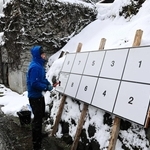 雪が降る中、衆院選のポスター掲示板を設置する男性＝新温泉町岸田