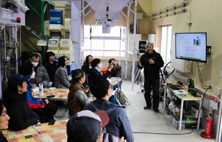 パタゴニアと連携し、環境を取り戻す「リジェネラティブ農業」に取り組む平峰拓郎さん（右端）＝豊岡市三宅