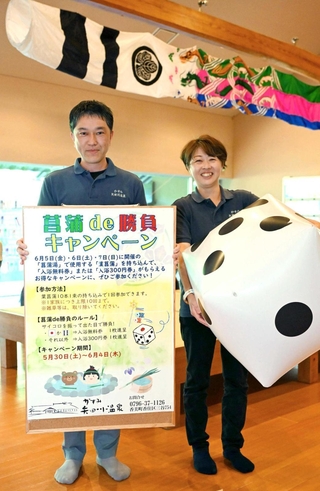 温泉に浮かべる葉ショウブを持ち込み、サイコロを振ると入浴券がもらえるキャンペーンを実施している＝かすみ矢田川温泉