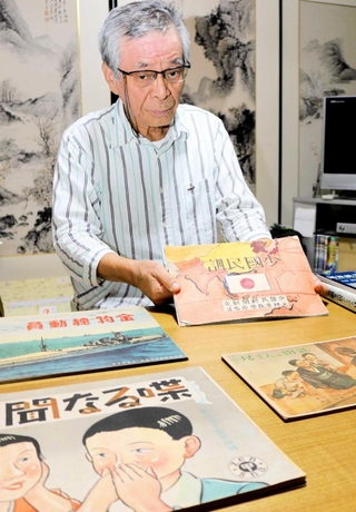 教員だった父が残した「国策紙芝居」を保管する川見章夫さん＝豊岡市出石町柳