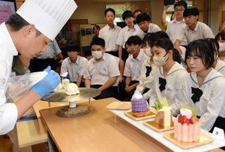 パティシエの作業に真剣な表情で見入る生徒ら＝八鹿青渓中学校