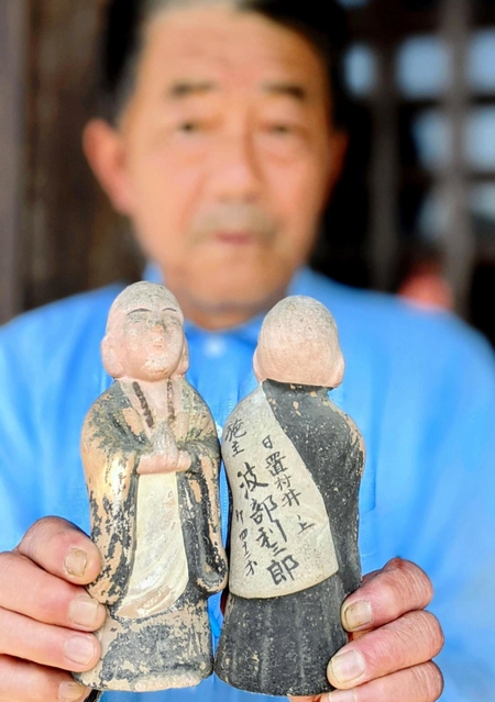 背中に奉納した施主の名が記された小さな地蔵像＝丹波篠山市日置