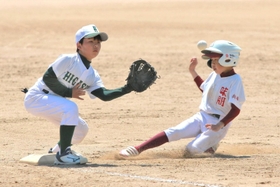 白熱したプレーを見せる味間少年野球団、篠山東野球少年団の選手たち＝丹波篠山総合スポーツセンター