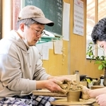 陶勝窯の市野勝磯さん（右）から一対一でサポートを受けながら陶芸体験した＝丹波篠山市今田町上立杭