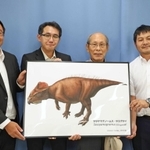 新属新種の角竜「ササヤマグノームス」のイメージ図を手に笑顔を見せる足立洌さん（右から２人目）ら＝３日午後、兵庫県庁