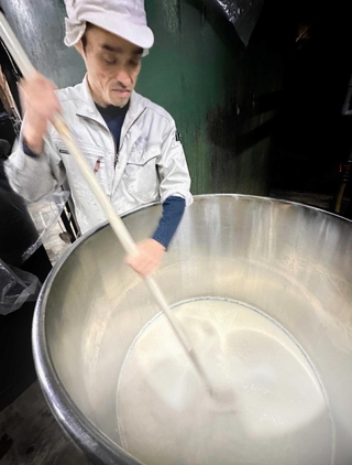 酒母を櫂で混ぜる杜氏の湊洋志さん＝丹波篠山市大沢