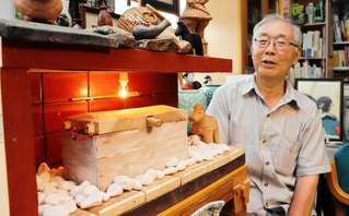 １０分の１ほどの大きさで再現した石棺と、制作した澤山伊知郎さん＝丹波篠山市市野々